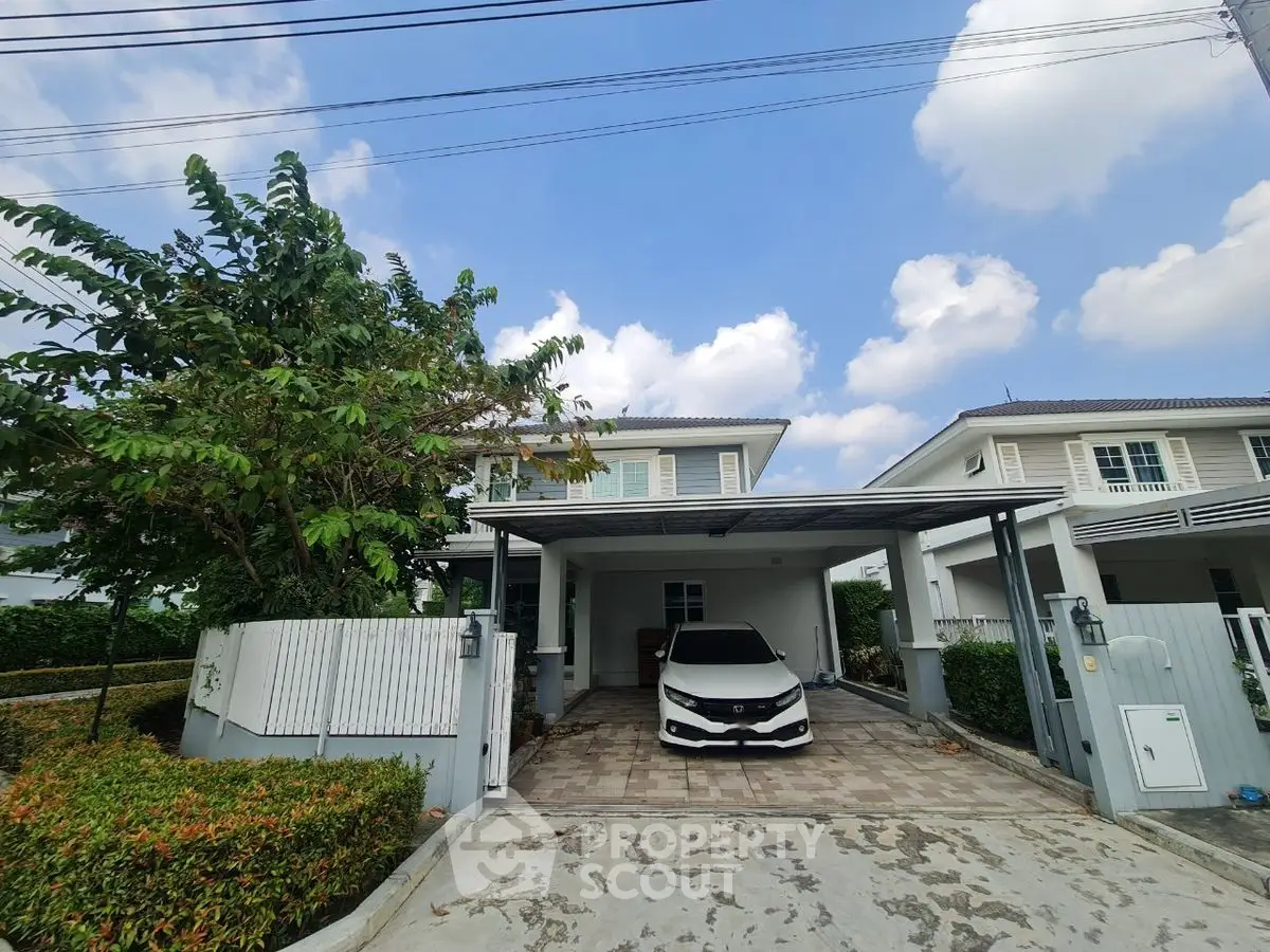 Charming suburban house with carport and lush greenery in a serene neighborhood.