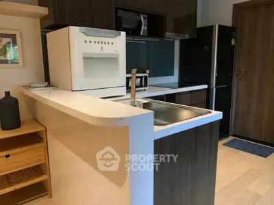 Modern kitchen with sleek appliances and stylish cabinetry in a contemporary home.