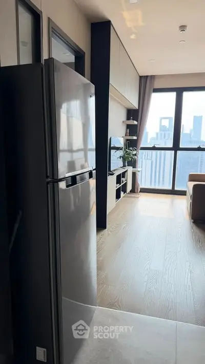 Modern apartment with sleek kitchen and stunning city view from living room.