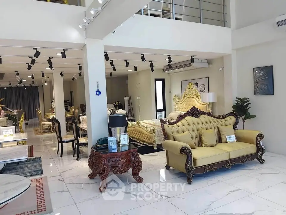 Luxurious open living room with elegant furniture and high ceilings, perfect for sophisticated living.