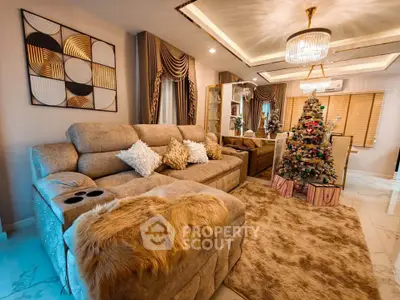 Luxurious living room with plush sofa, elegant decor, and festive Christmas tree