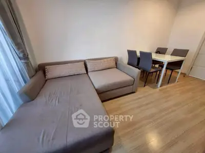 Modern living room with stylish sofa and dining area, perfect for cozy gatherings.