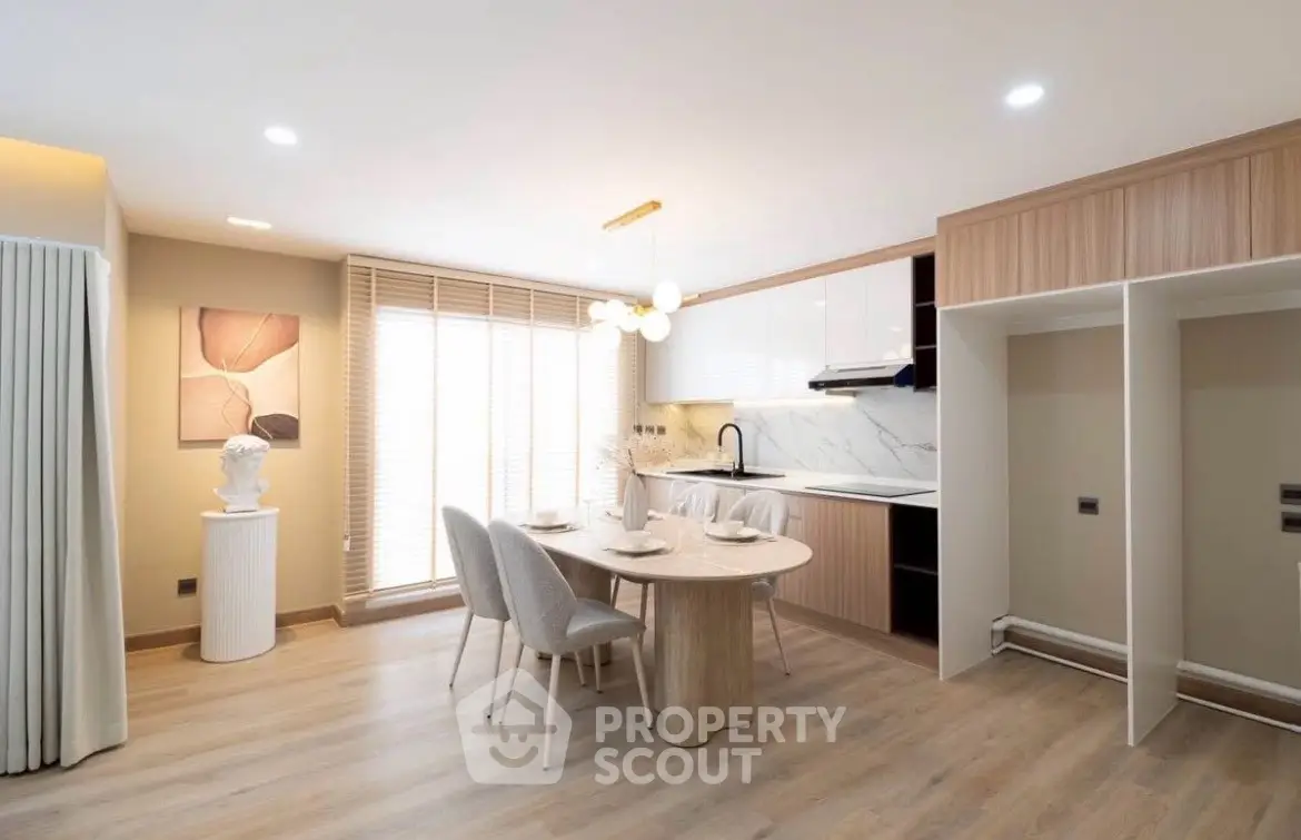 Modern open-layout kitchen with dining area and stylish decor