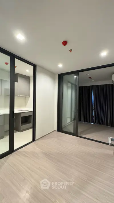 Modern apartment interior with sliding glass doors and minimalist design