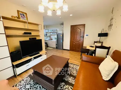 Cozy living room with open kitchen, elegant decor, and warm lighting