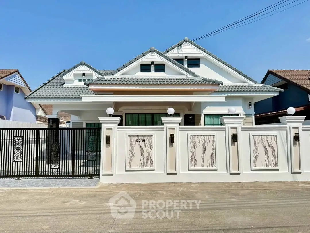 Stunning modern house with elegant facade and gated entrance in a serene neighborhood.