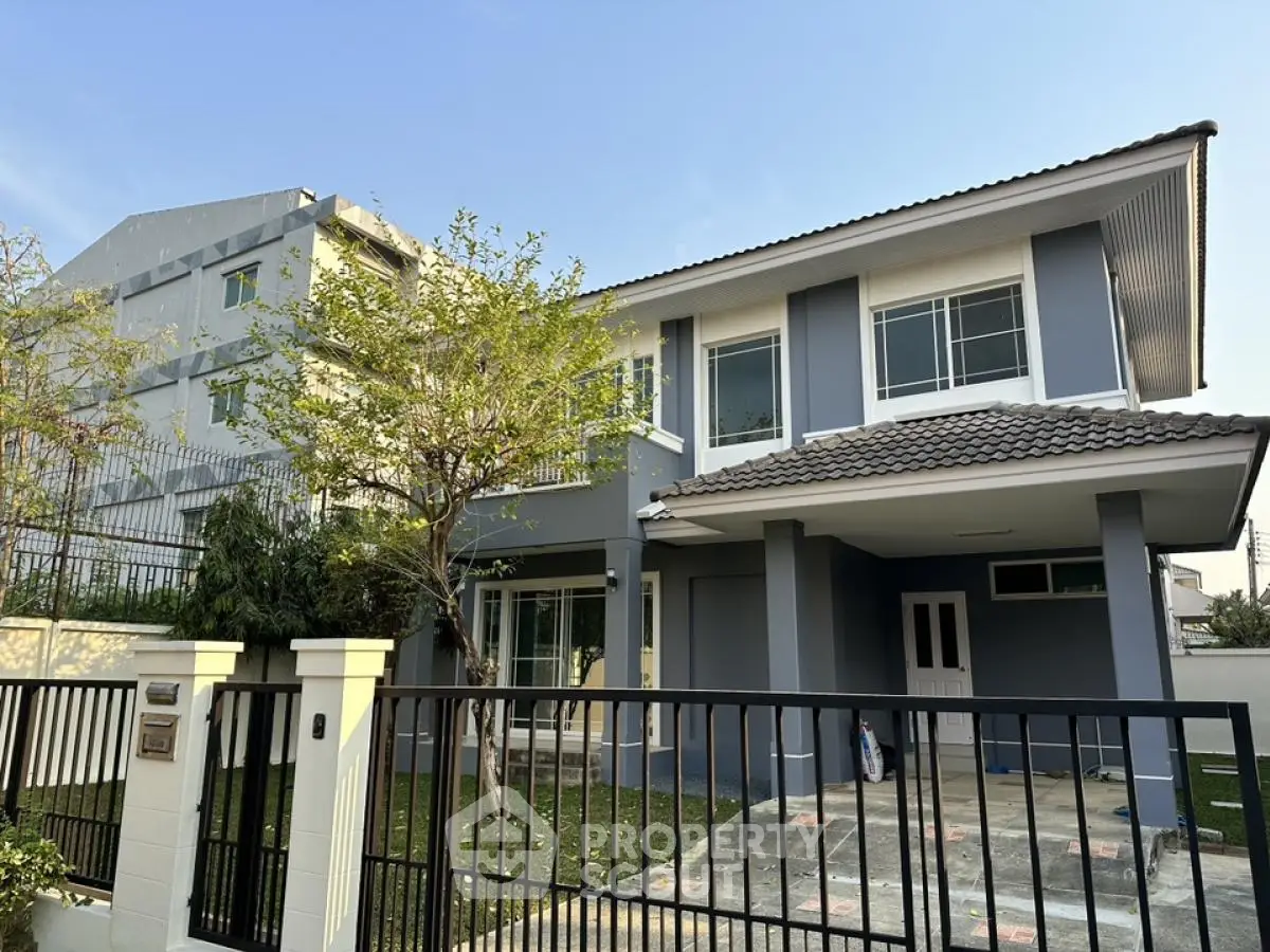 Charming two-story house with modern design and spacious front yard