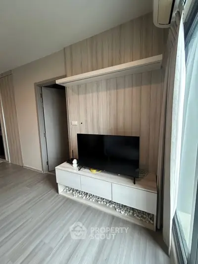 Modern living room with sleek TV stand and wood panel accent wall