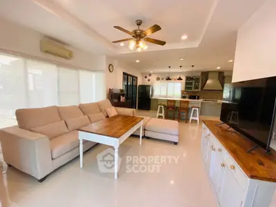 Spacious living room with cozy sectional sofa and open kitchen layout