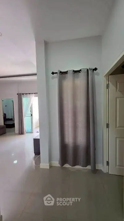 Spacious modern living area with elegant curtains and open layout