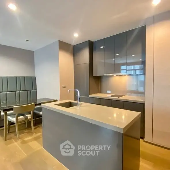 Modern kitchen with sleek cabinetry and dining area in luxury apartment
