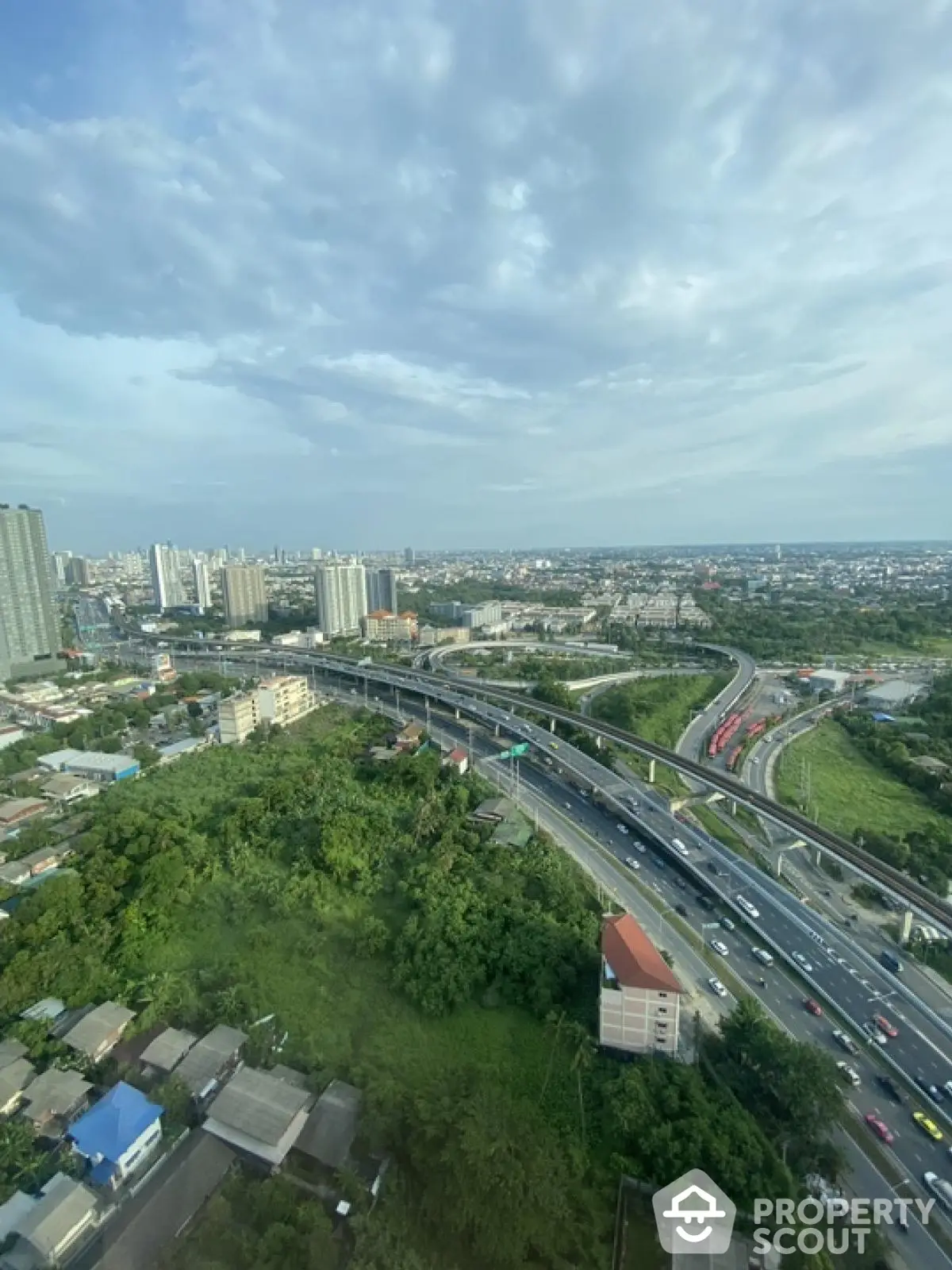 Stunning cityscape view with highways and lush greenery, perfect for urban living enthusiasts.