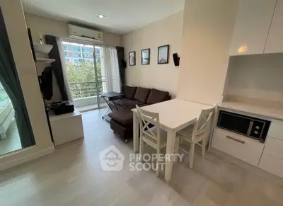 Modern living room with balcony view, cozy sofa, and dining area in stylish apartment.