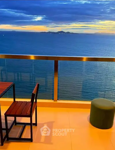 Stunning ocean view from a modern balcony at sunset, perfect for relaxation.