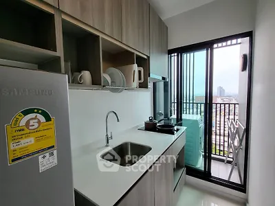 Modern kitchen with sleek cabinetry and balcony view in urban apartment