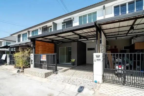 Modern townhouse with covered parking and sleek exterior design