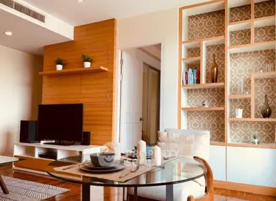 Stylish living room with modern decor, wooden accents, and elegant shelving in a cozy apartment.