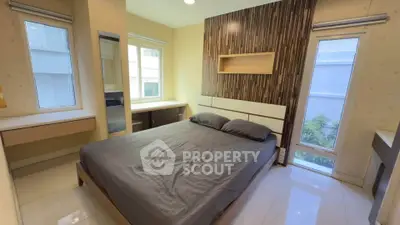 Modern bedroom with stylish decor and ample natural light