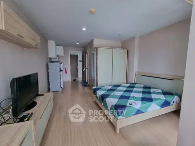 Spacious modern bedroom with wooden flooring and stylish furniture