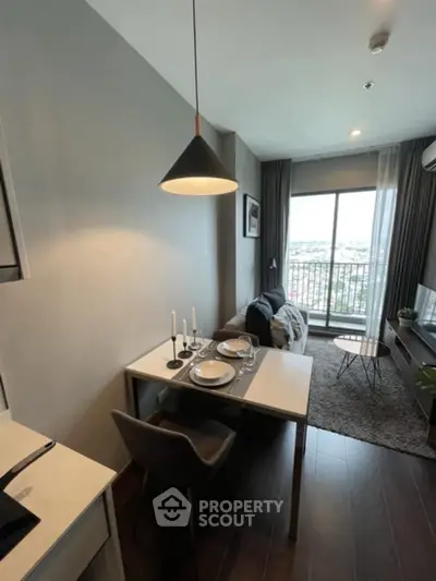 Modern living room with dining area and large window offering city view