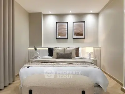 Elegant bedroom with modern decor, cozy lighting, and stylish artwork, perfect for relaxation and comfort.