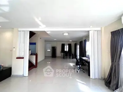 Spacious open-plan living area with modern decor and ample natural light.