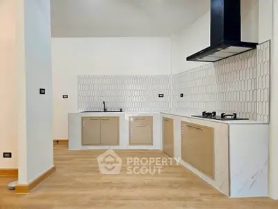 Modern kitchen with sleek cabinetry and gas stove in open layout design