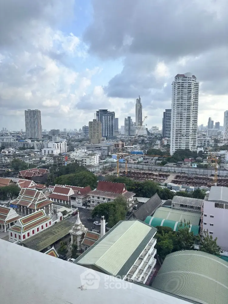 Stunning cityscape view from high-rise building showcasing urban skyline and architectural diversity.