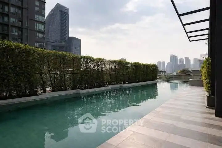 Luxurious rooftop pool with city skyline view in modern urban setting.