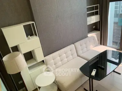 Modern living room with stylish furniture and large windows offering natural light.