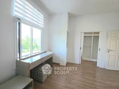 Bright and spacious bedroom with large window and built-in closet