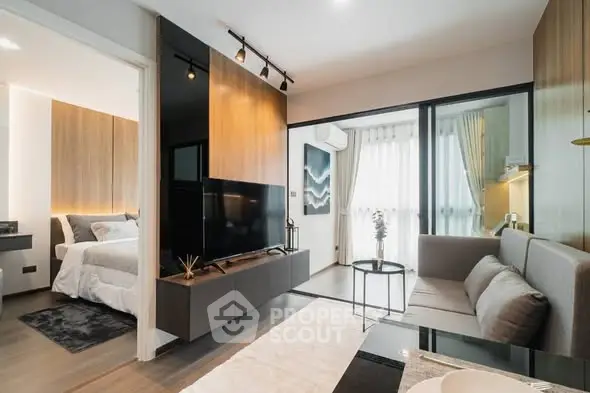 Modern living room with sleek design and cozy bedroom view in a stylish apartment.