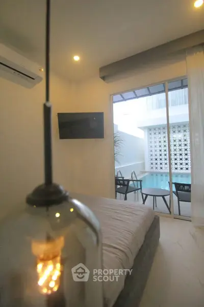 Modern bedroom with pool view and stylish lighting in a luxury apartment