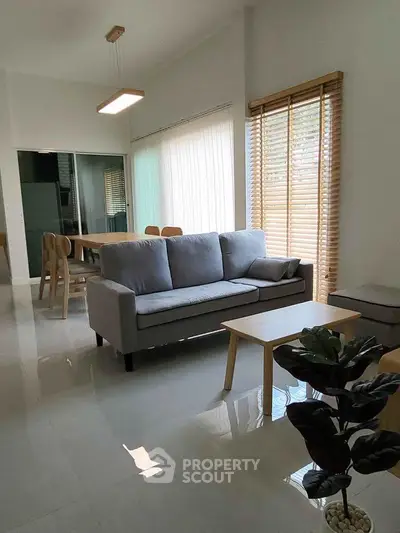 Modern living room with sleek furniture and large windows for natural light