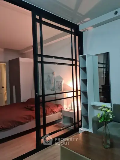 Modern bedroom with sliding glass doors and cozy lighting