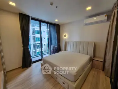 Modern bedroom with large window and balcony view in a stylish apartment.