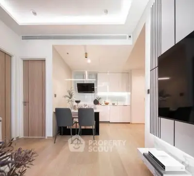 Modern open-plan living room and kitchen with sleek design and elegant furnishings.