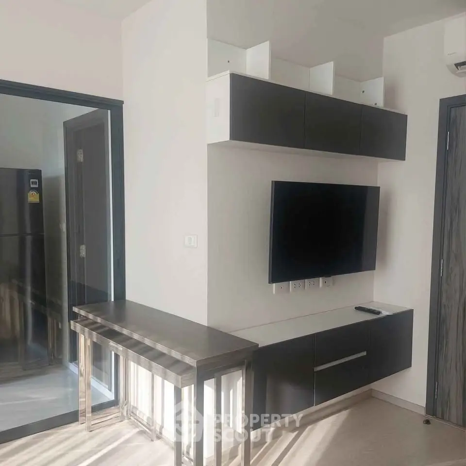 Modern living room with sleek TV unit and stylish furniture in a contemporary apartment.