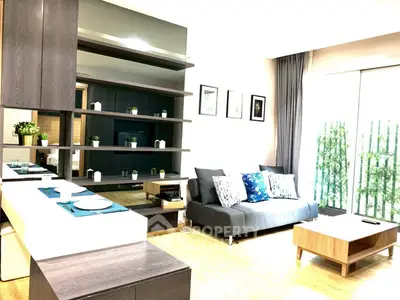 Modern living room with sleek furniture and large windows for natural light.