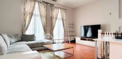 Spacious living room with modern decor and large windows for natural light.