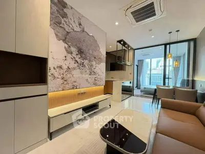 Modern open-plan living room with stylish furniture and large windows offering city views.