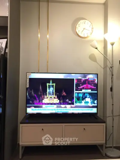 Modern living room with stylish TV setup and elegant lighting, perfect for cozy evenings.