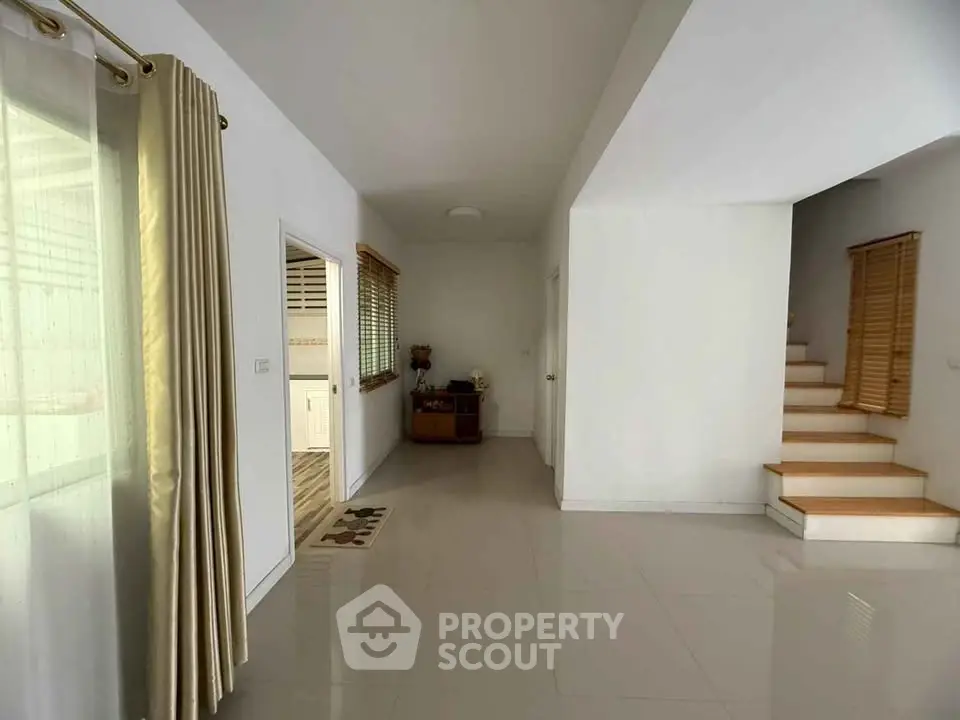 Spacious modern interior with staircase and natural light, ideal for contemporary living.