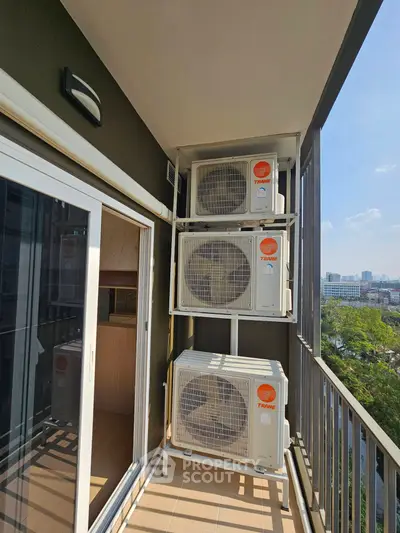 Modern balcony with air conditioning units and city view, perfect for urban living.