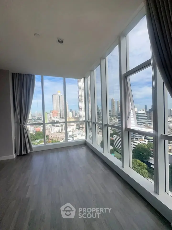 Spacious corner unit with floor-to-ceiling windows offering a stunning city view.