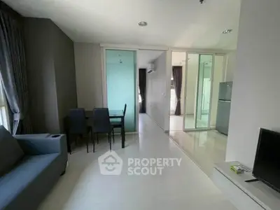Modern apartment interior with sleek design and open layout, featuring dining area and living space.