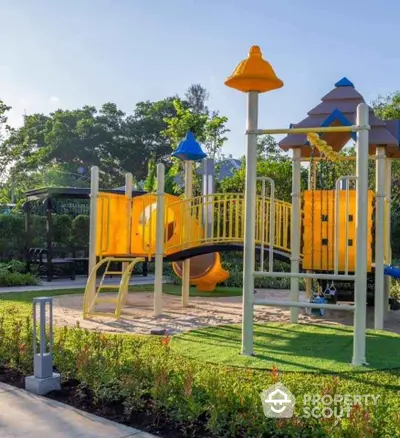 Vibrant playground in lush garden setting, ideal for family-friendly real estate.