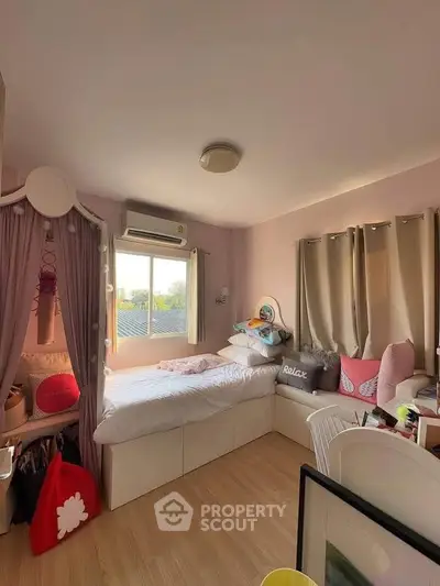 Cozy bedroom with natural light, stylish decor, and ample storage space, perfect for relaxation and comfort.