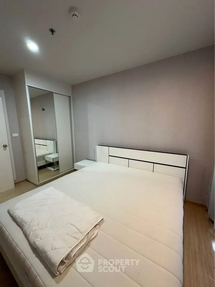 Modern bedroom with minimalist design and mirrored wardrobe