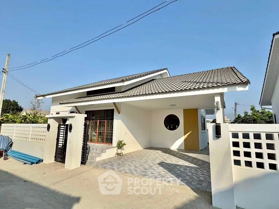 Charming single-story house with modern design and spacious driveway in a serene neighborhood.